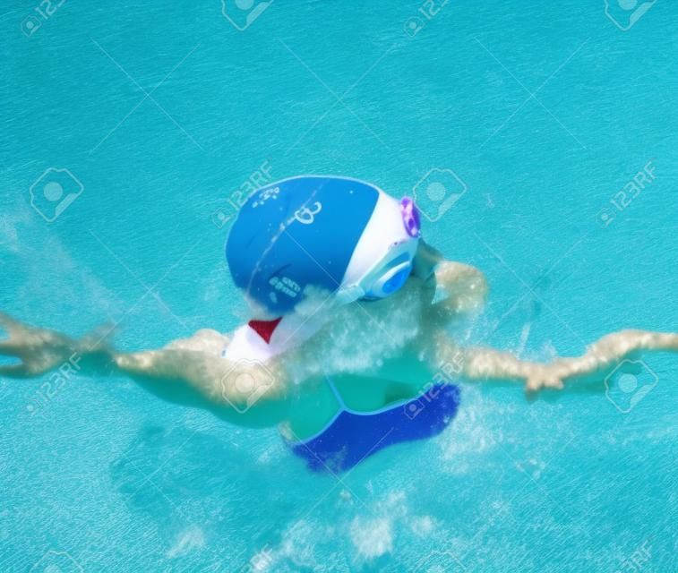 Girl swims in the pool in freestyle