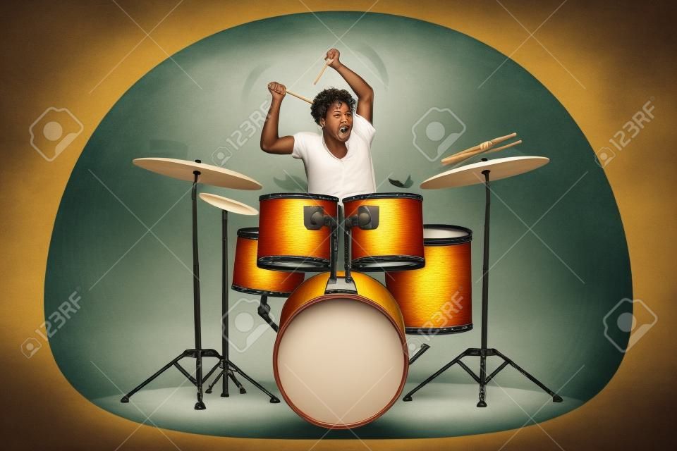 Man playing on drum with sticks