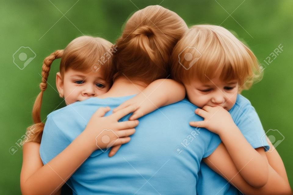 sad children hugging his mother