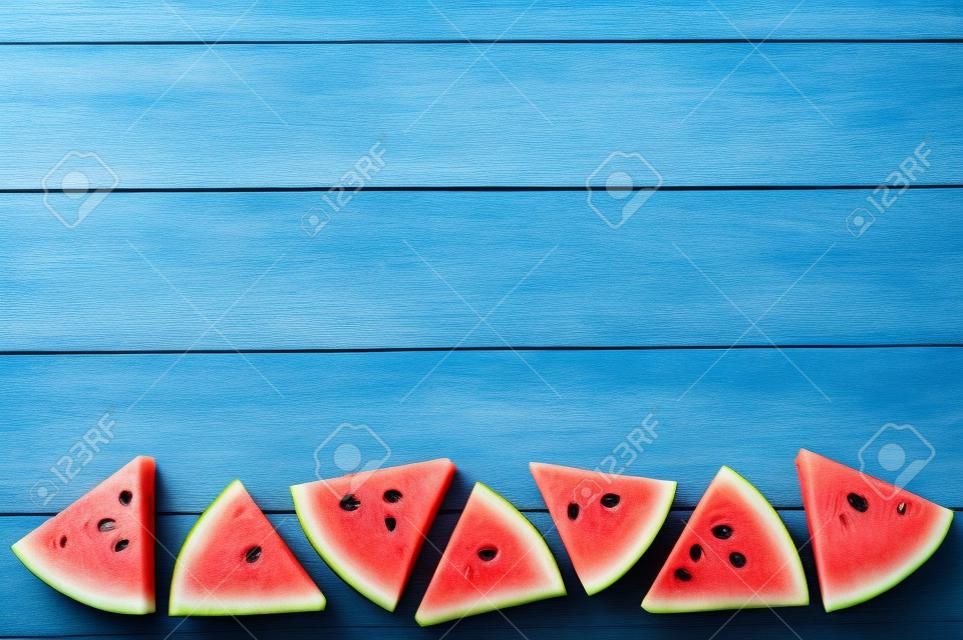 Slice of Watermelon on blue wooden background