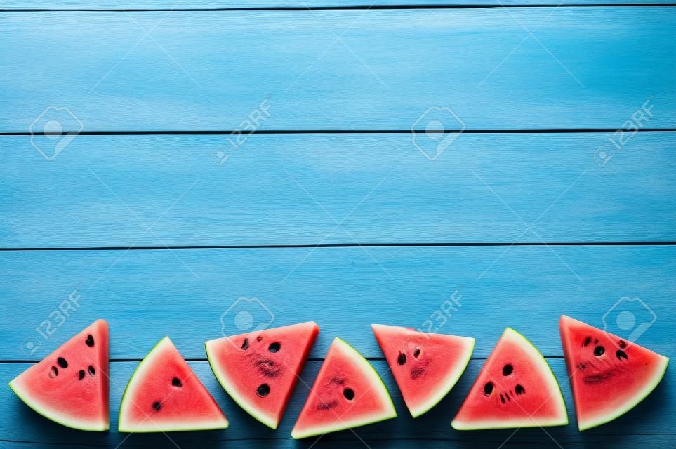 Slice of Watermelon on blue wooden background