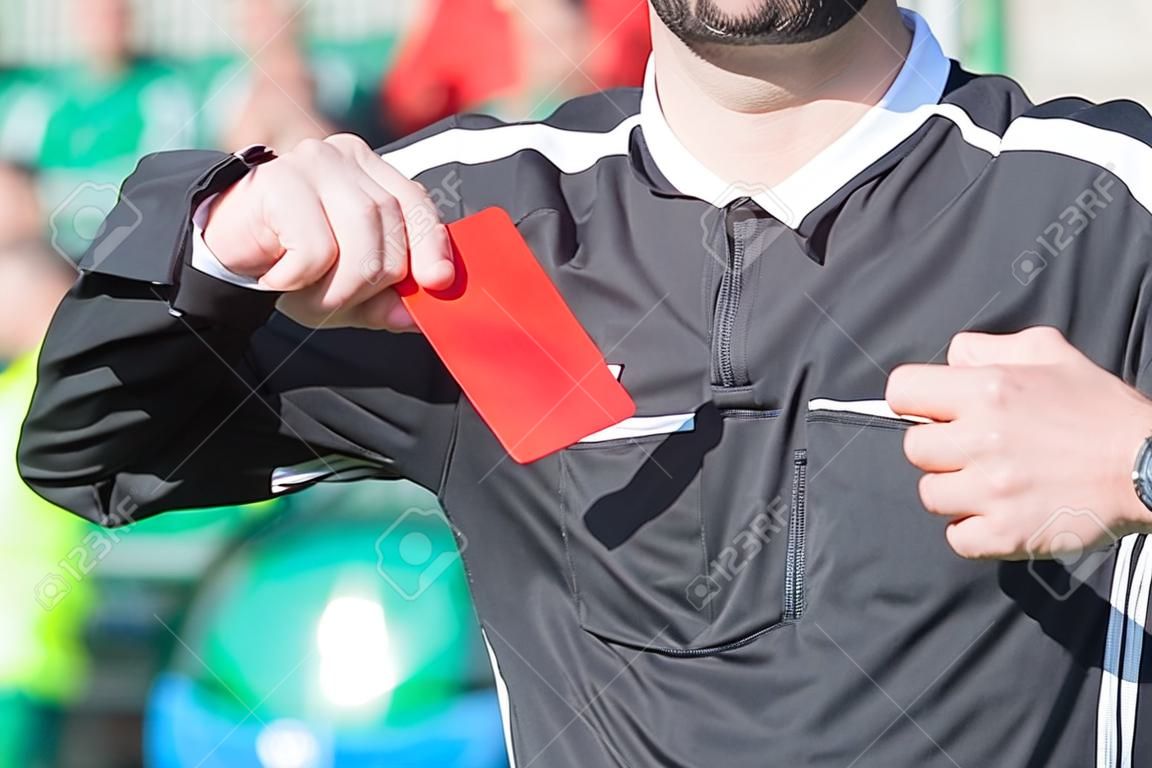 Voetbalscheidsrechter met de rode kaart.
