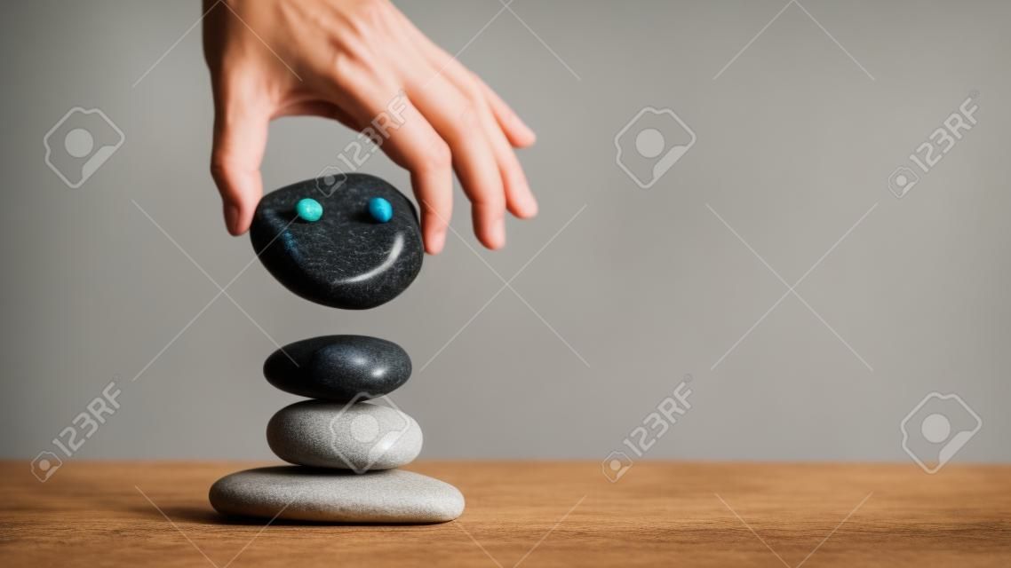 Hand Setting zen meditation stone Stack to Balance. Balancing Body, Mind, Soul and Spirit. Mental Health Practice for relaxation balance and harmony spirituality or spa wellness.