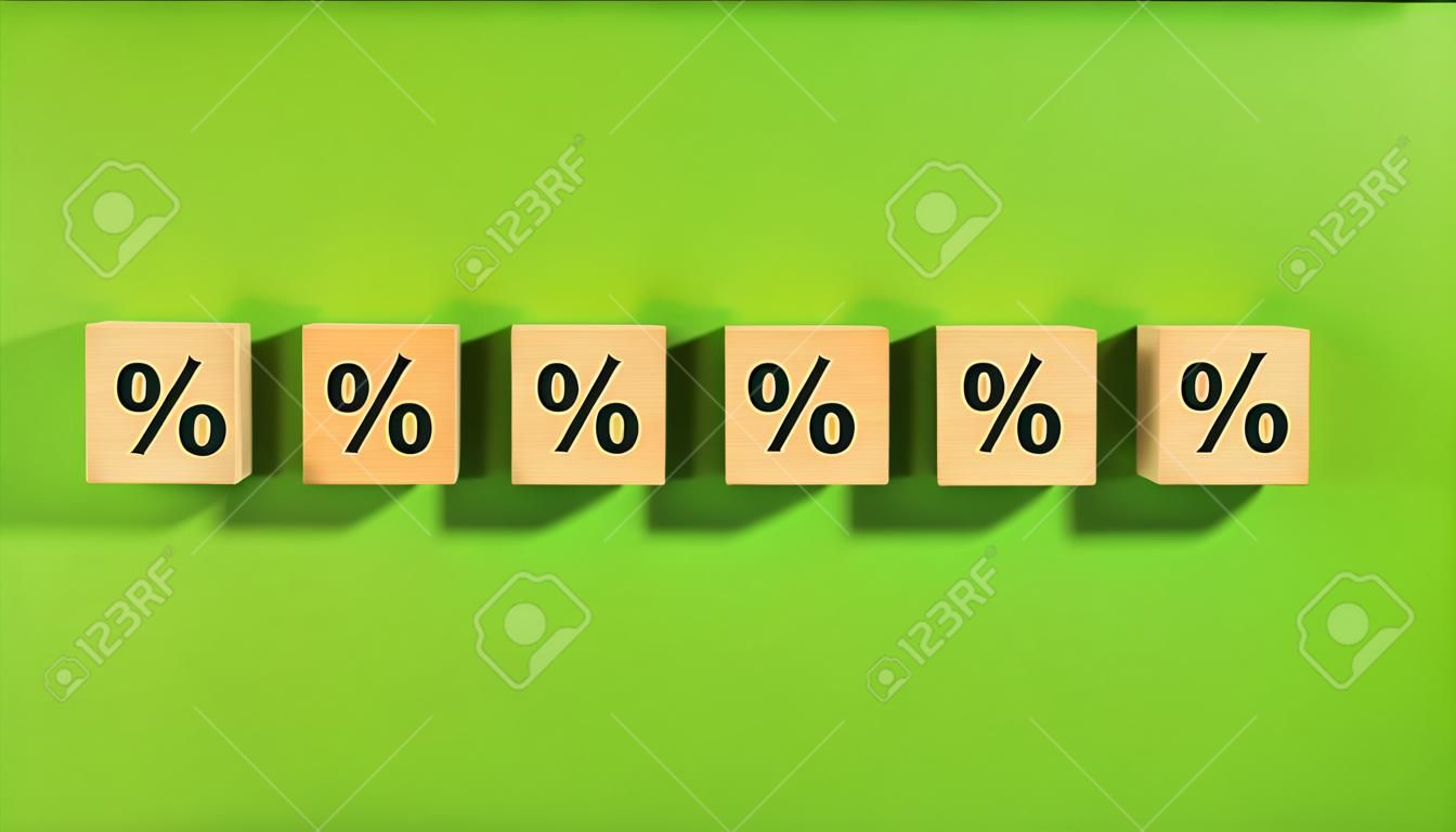 Wooden cubes with a up arrow and percentage symbol.