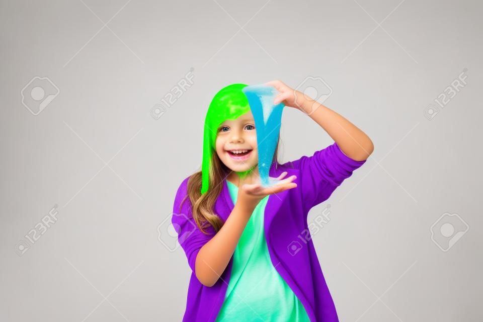 Young girl playing with slime. Isolated on white background.