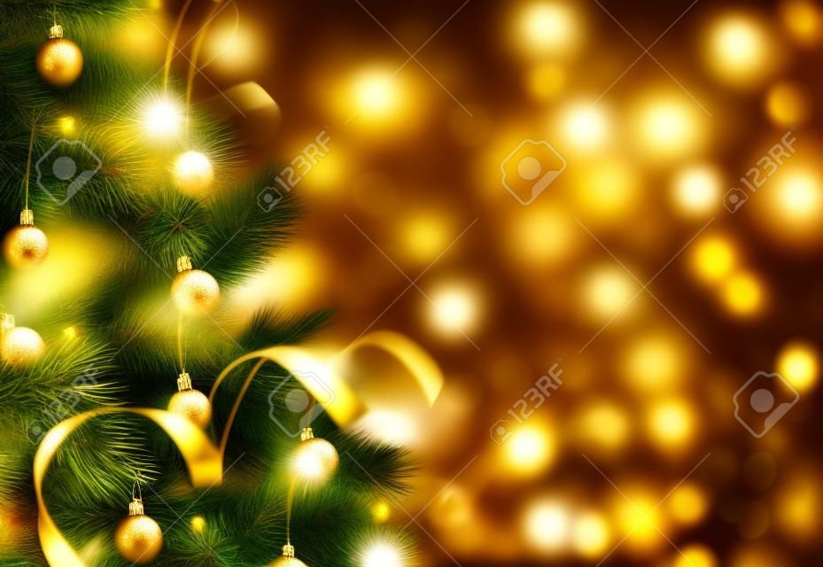 Gold Christmas background of defocused lights with decorated tree
