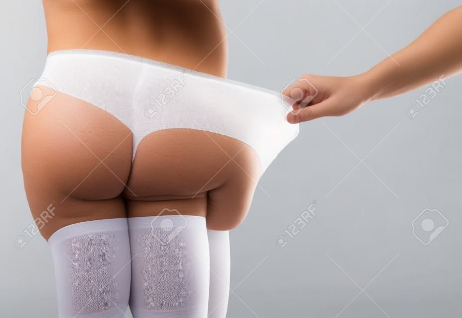 Close-up Of Woman's Hand Pulling Man's Underwear On White Background Stock  Photo, Picture and Royalty Free Image. Image 22001940.