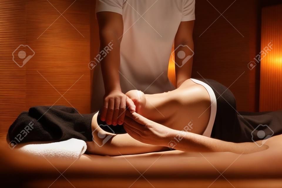 Masseur Doing Massage On Mature Woman In Spa