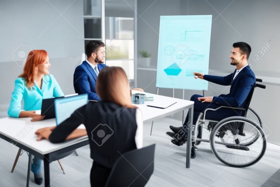 Disables Young Businessman Giving Presentation To His Colleague