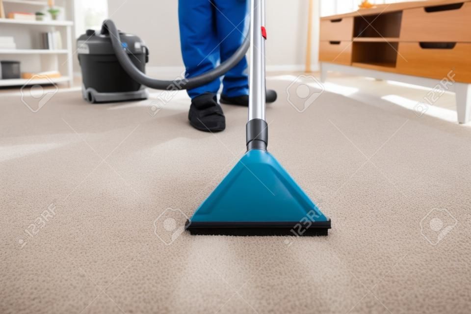 Photo Of Janitor Cleaning Carpet With Vacuum Cleaner