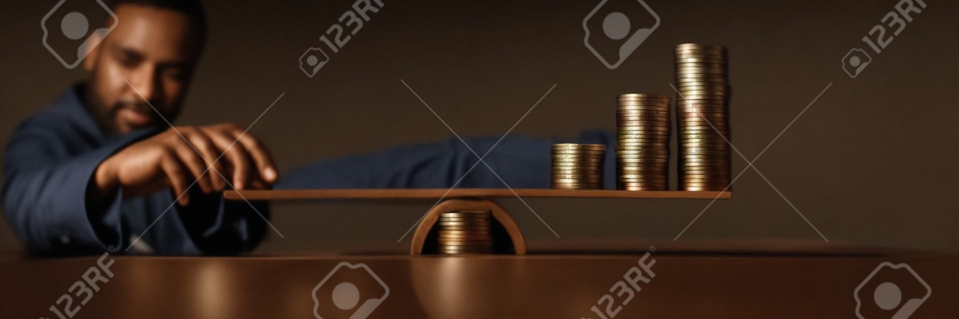 Man Holding Two Coin Stacks To Compare