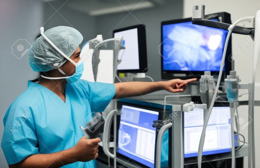 The surgeon looks at the monitor during surgical operation