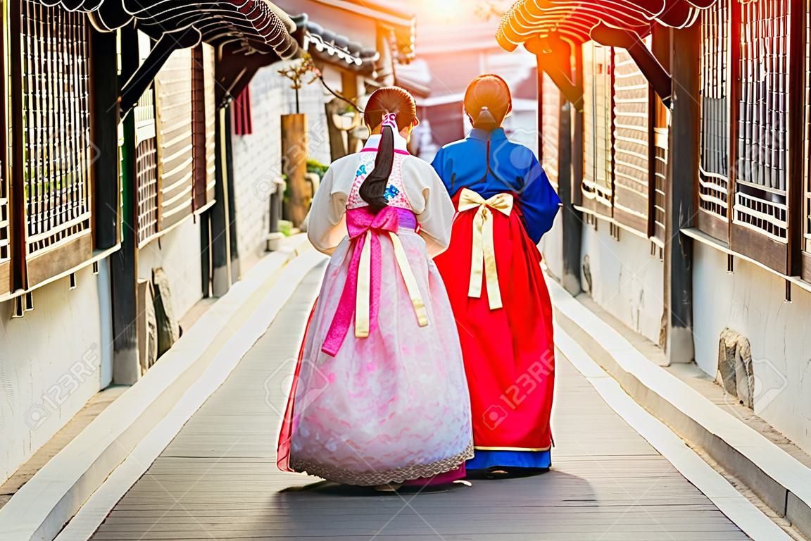Korean lady in Hanbok or Korea gress and walk in an ancient town in seoul, Seoul city, South Korea.
