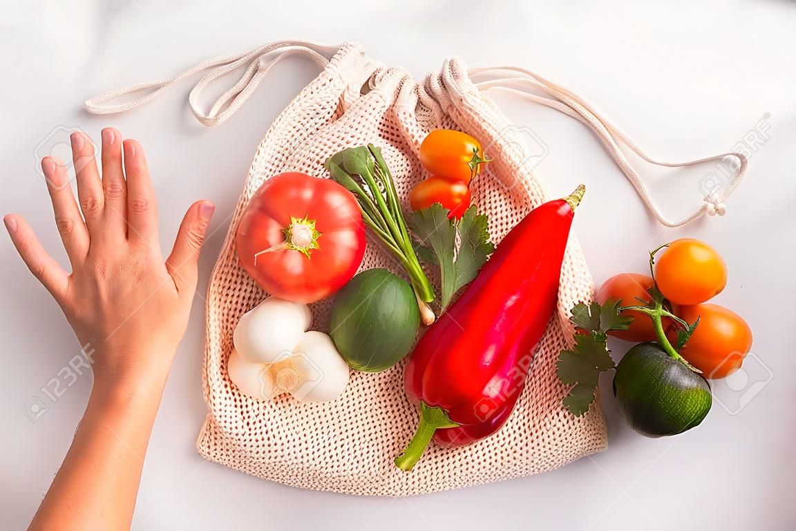 Vegetables above reusable mesh cotton bag, plastic free zero waste concept