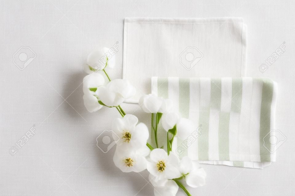 Flat lay Beautiful cotton branch on fabric kitchen towels. top view copy space. Natural cotton fabric texture. Delicate white cotton flowers. Light color cotton background. Eco textiles. Fabric backdrop