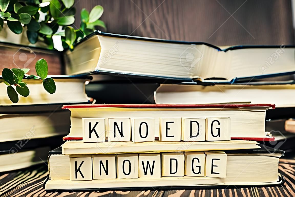Knowledge text in book, education learning concept with opening book or textbook in old library, stack piles of literature text academic archive on reading desk and aisle of bookshelves in school study class room background close up