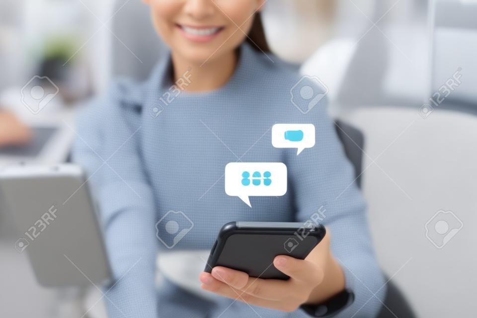 Woman using smartphone to do work business, social network, communication with chat icon.