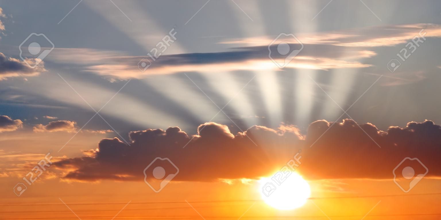 beautiful bright sunset in cloudy sky
