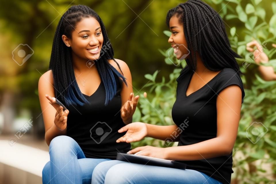 A shot of two college students having a discussion on campus