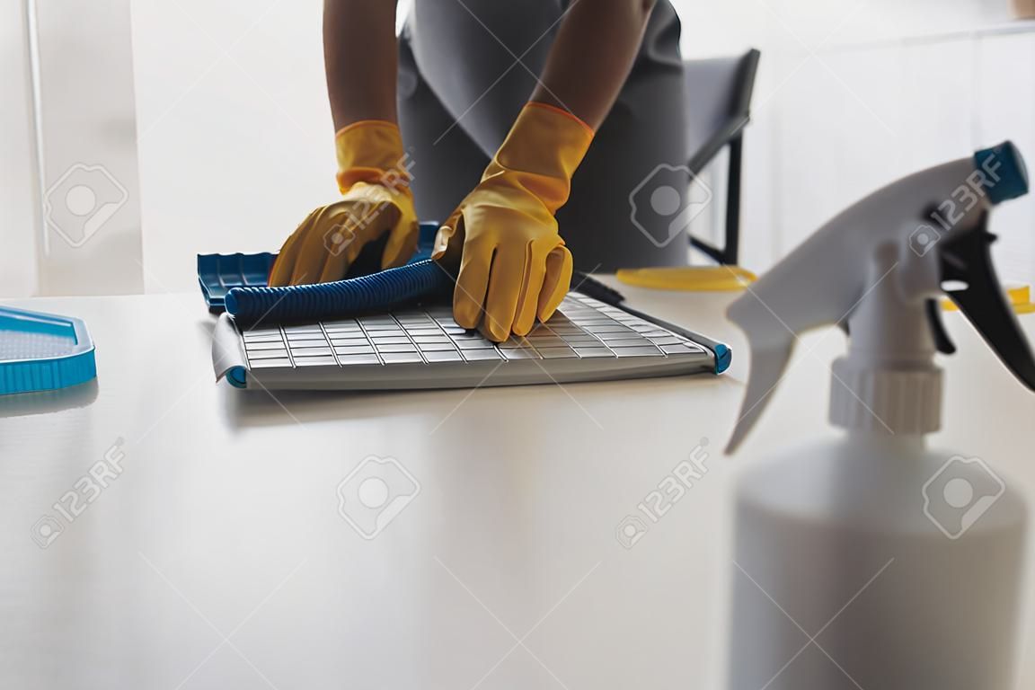 Office Cleaning Service. Janitor Spraying Desk. Workplace Hygiene