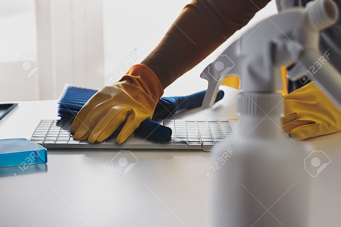 Office Cleaning Service. Janitor Spraying Desk. Workplace Hygiene