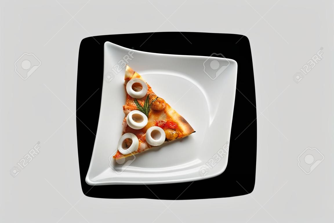 Seafood Pizza Slice in white dish on a black background