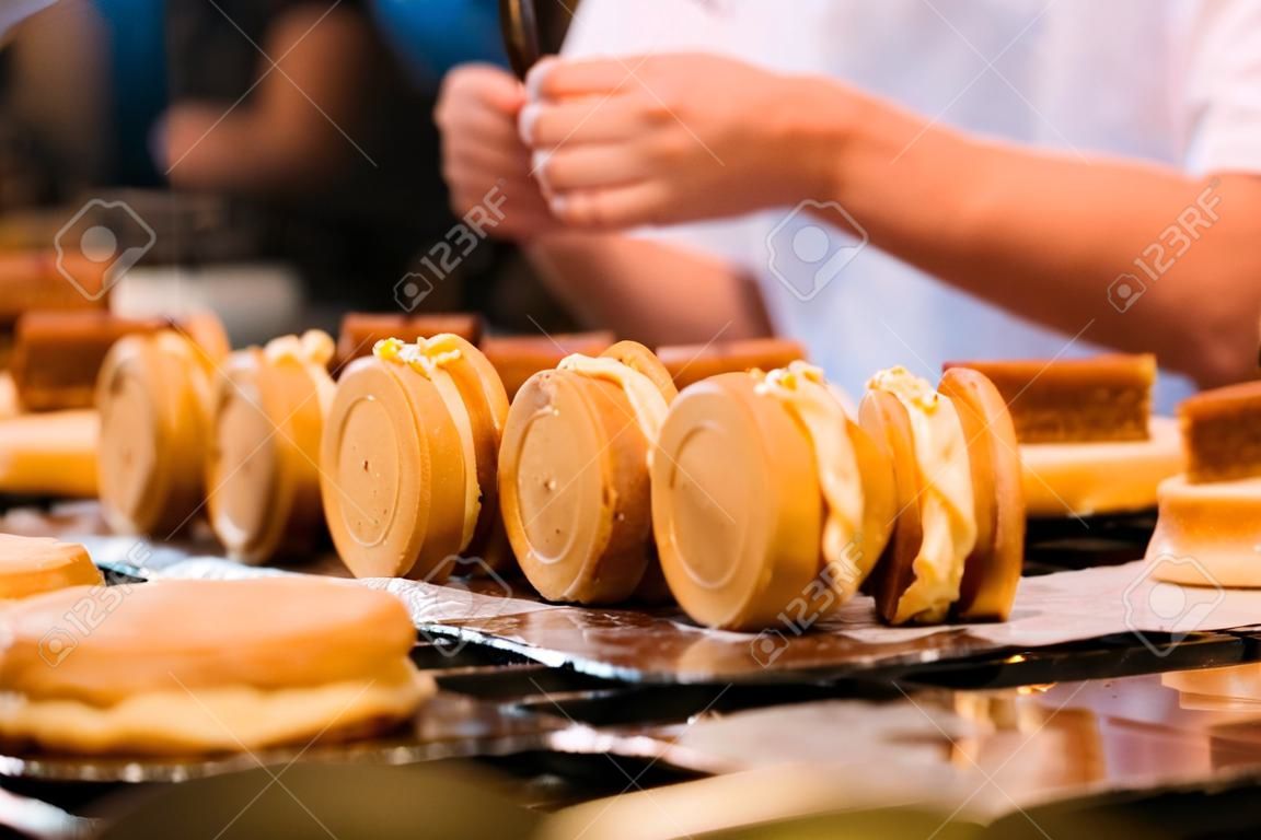 Crop image of a tasty pastry cream flavored Wheel Pies (also called custard pancake). Wheel Pies are a popular snack in Taiwan and Jiufen. Taiwanese food concept. Dessert time.