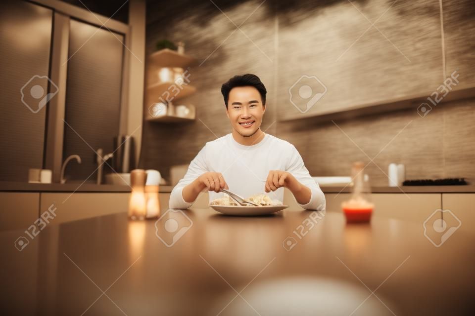 Photo of young handsome man good mood enjoy tasty meal seafood steak cuisine diet calories yummy indoors