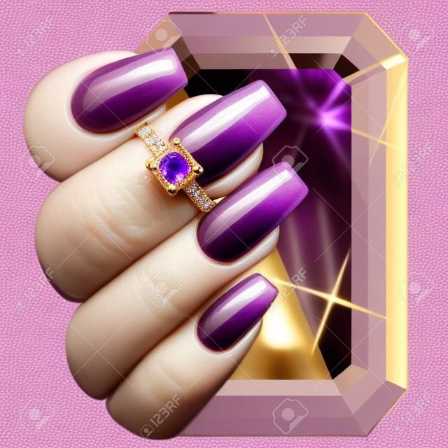 Golden ring with purple amethyst on a human hand with violet nails.