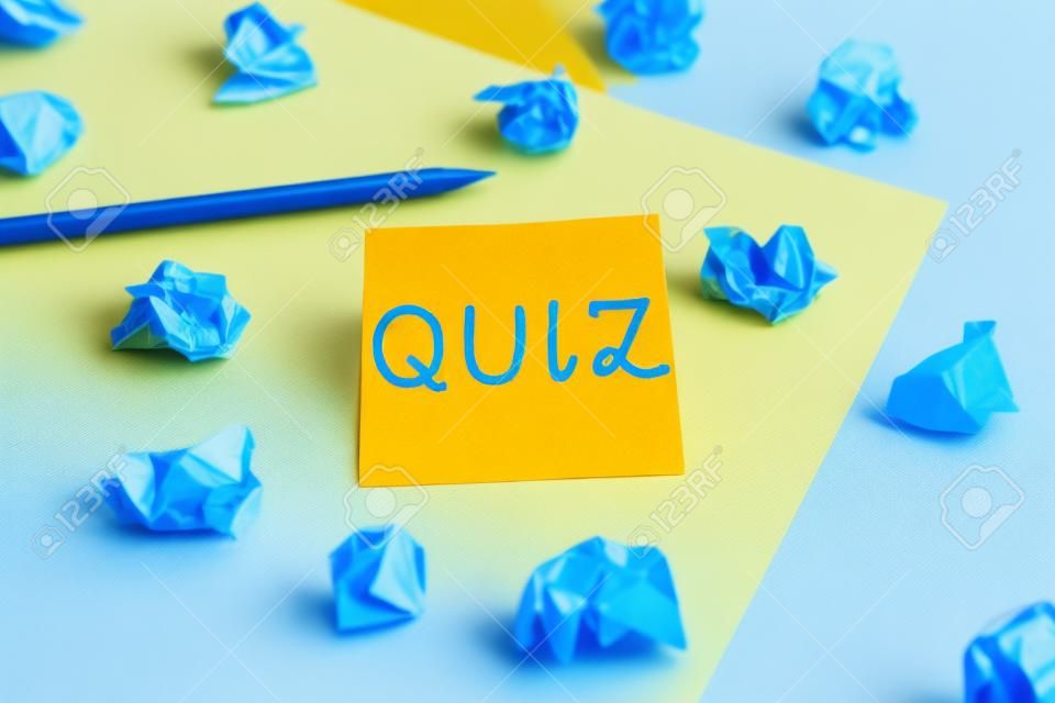 Word writing text Quiz. Business photo showcasing form of game in which the players attempt to answer questions correctly Colored crumpled papers empty reminder blue yellow background clothespin