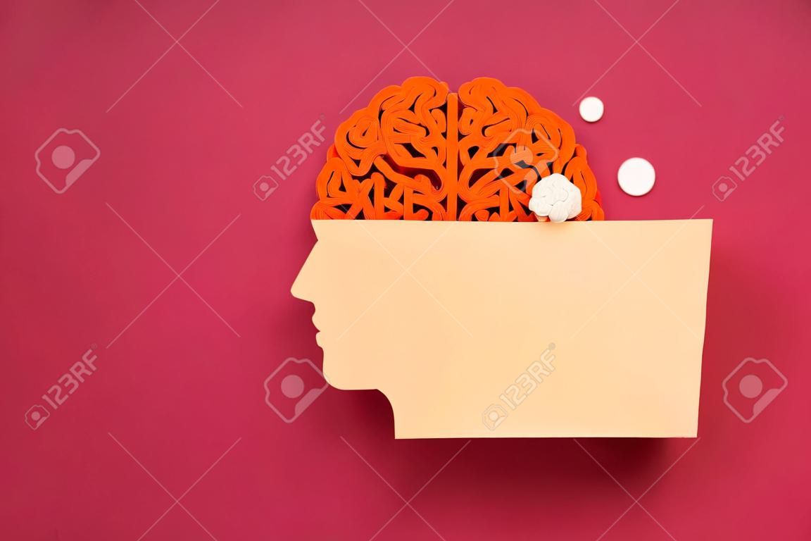 Paper head with decorative brain on red background, space for text