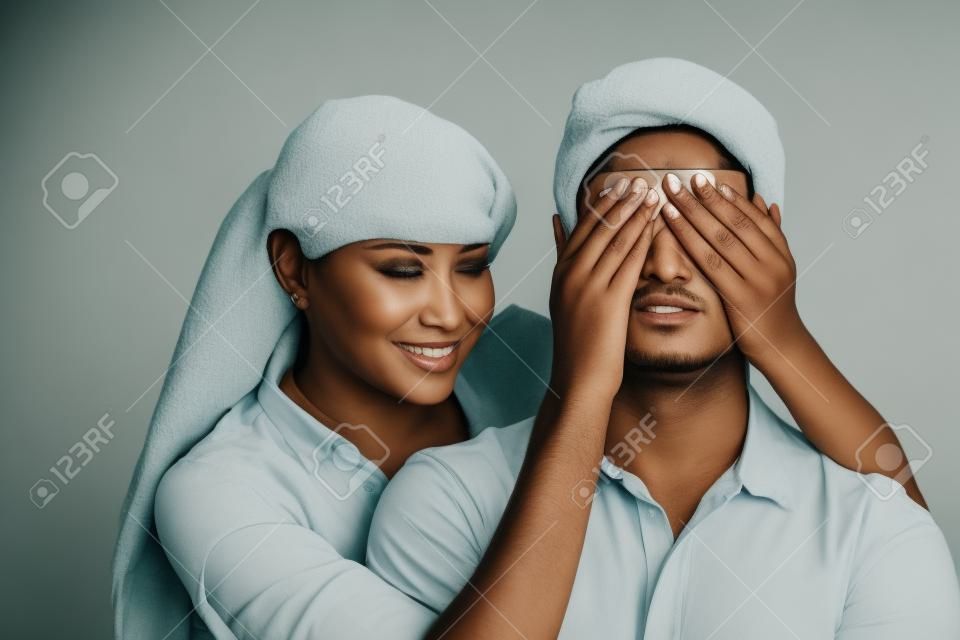 Woman covering a man's eyes
