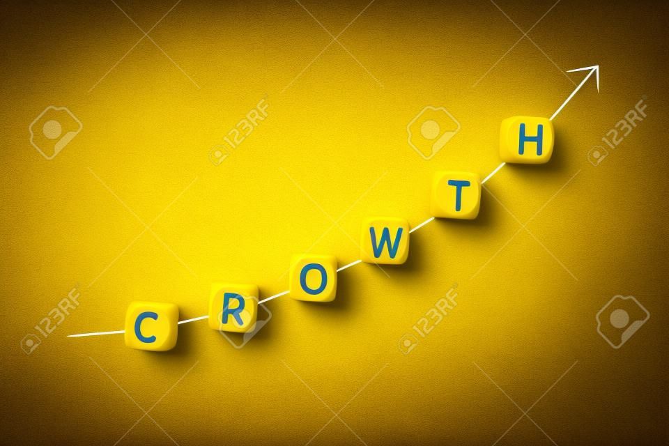 Concetto di crescita. Freccia in aumento e parola su blocchi di legno su sfondo giallo. Copia spazio