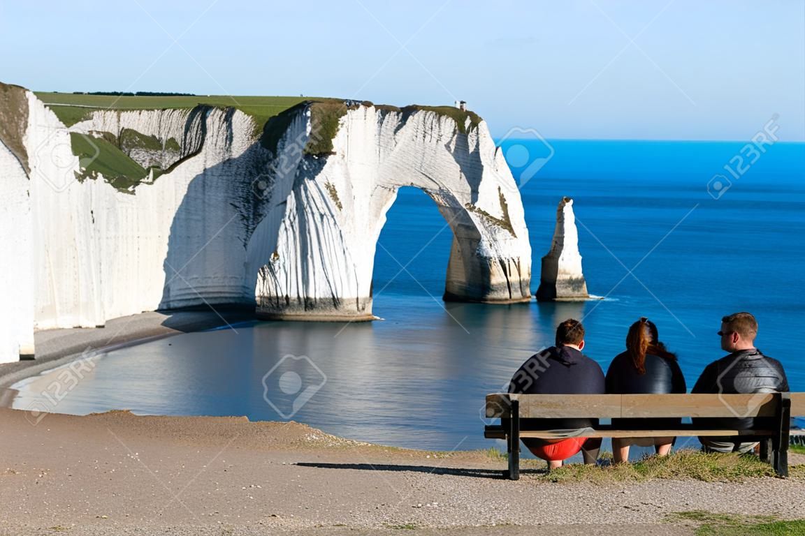 Four people enjoying the views of the Cliffs of Etretat, Normandy, France.