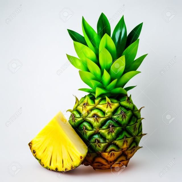 Whole pineapple and sliced slice nearby isolated on a white background
