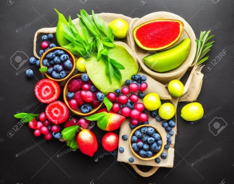 Delicious raw fruit on dark background. Healthy food concept. top view, flat lay