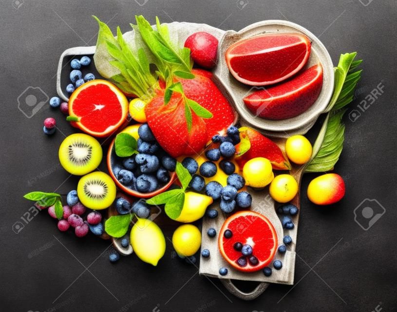 Delicious raw fruit on dark background. Healthy food concept. top view, flat lay