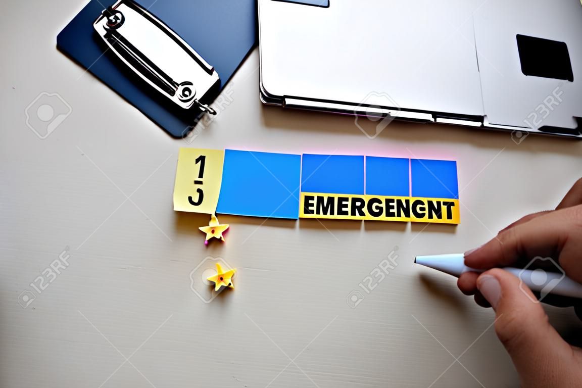 Emergency Management text on sticky notes with office desk concept