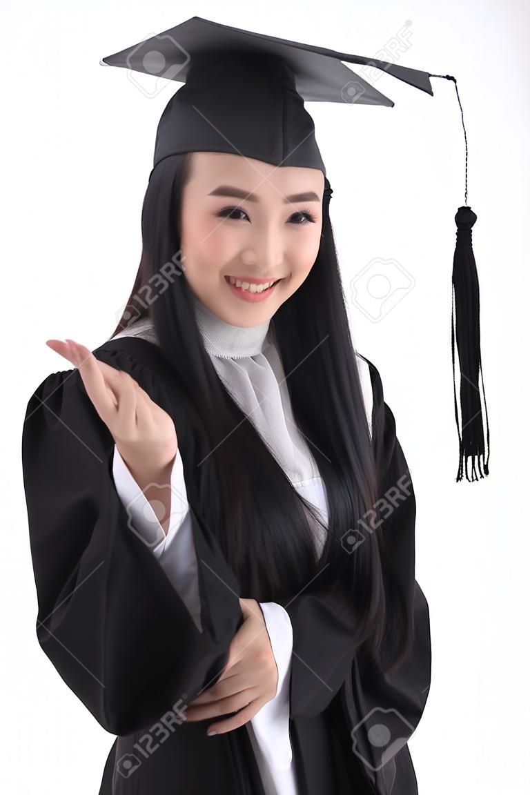 An Asian woman with a graduation hat and clothes in the studio, isolated on white