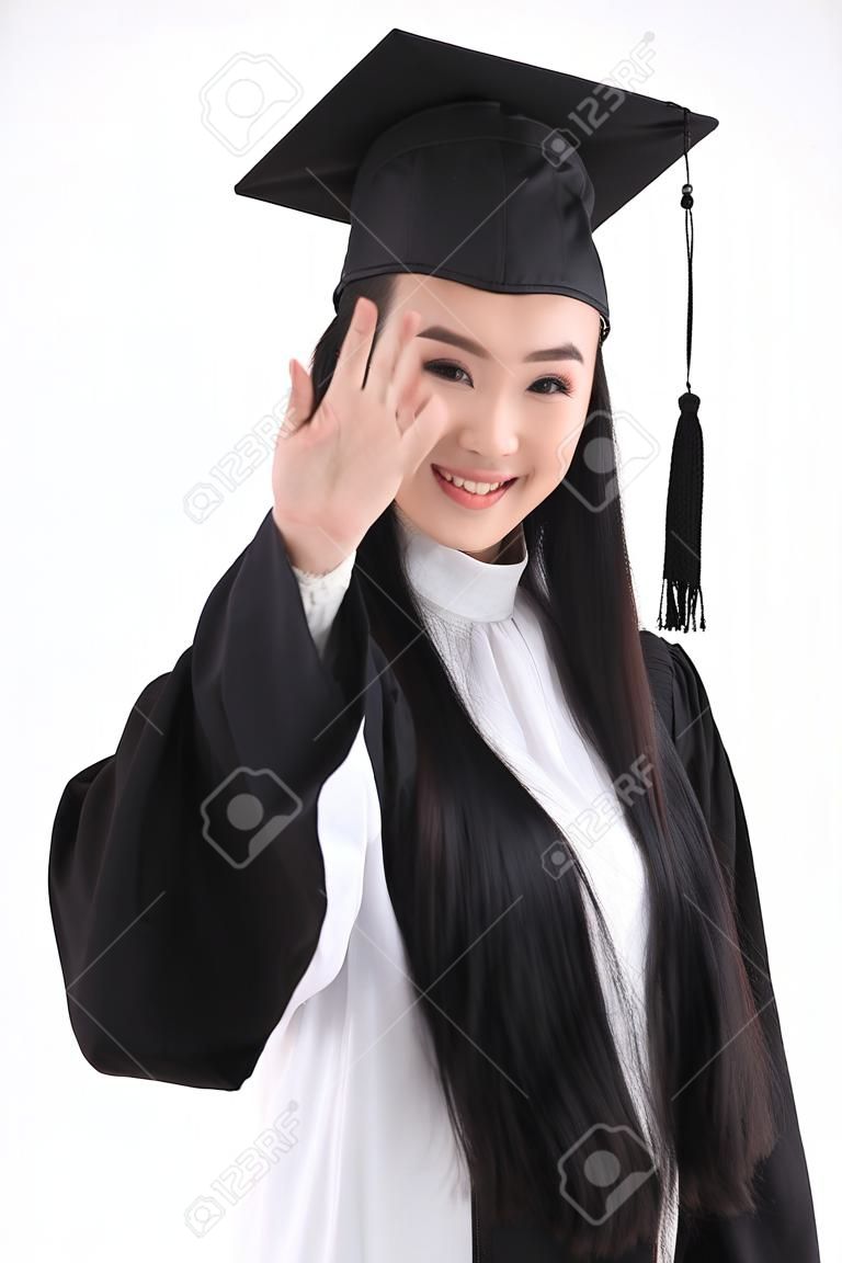 Azjatka z kapeluszem i ubraniami na zakończenie szkoły odizolowana na białym