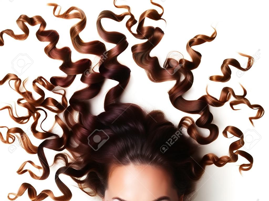 curly hair and part of womanâ€™s face, looking at the camera