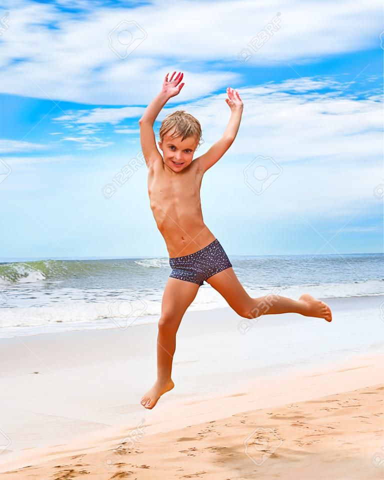 jumping boy on the beach with sea on background
