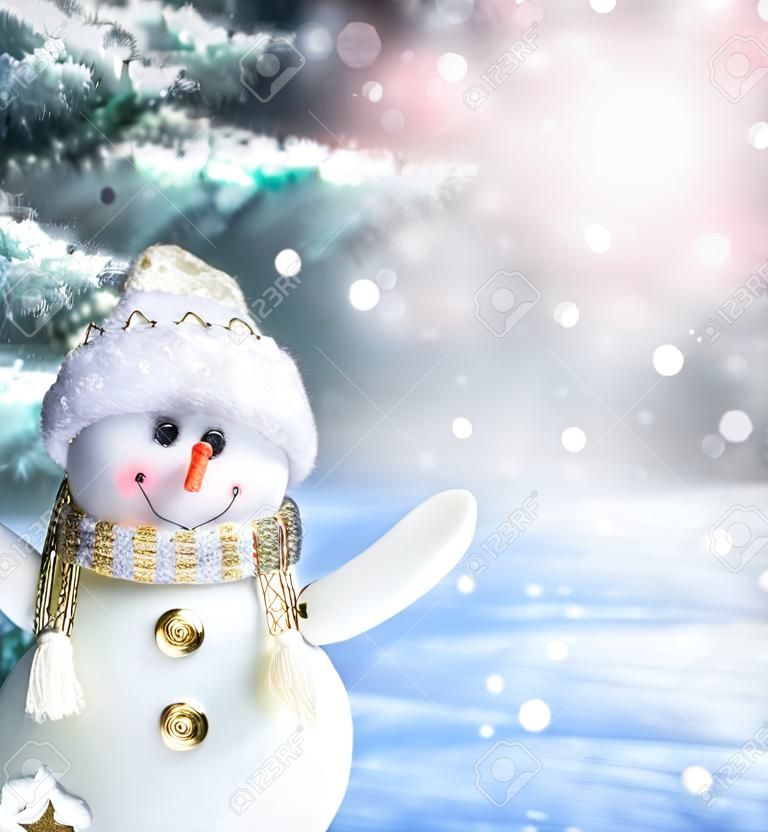 Merry christmas and happy new year greeting card. Happy snowman standing in winter christmas landscape.Snow background