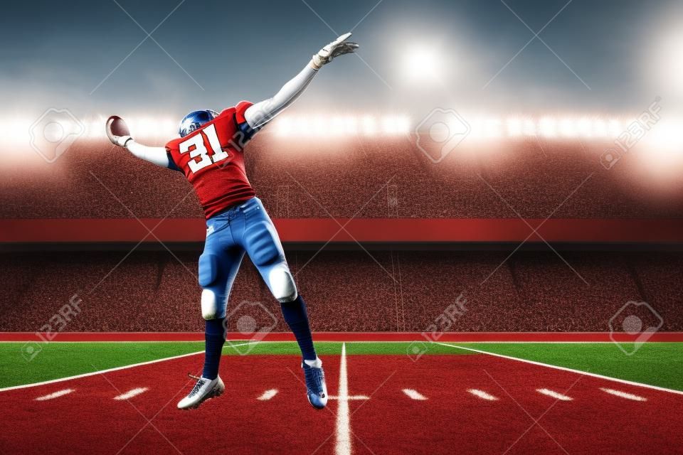 Football Player with a red uniform catching a ball on a stadium.