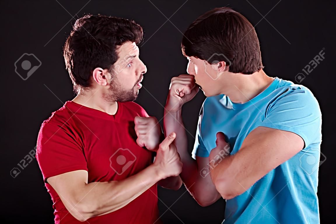 A man threatening the other one with a fist