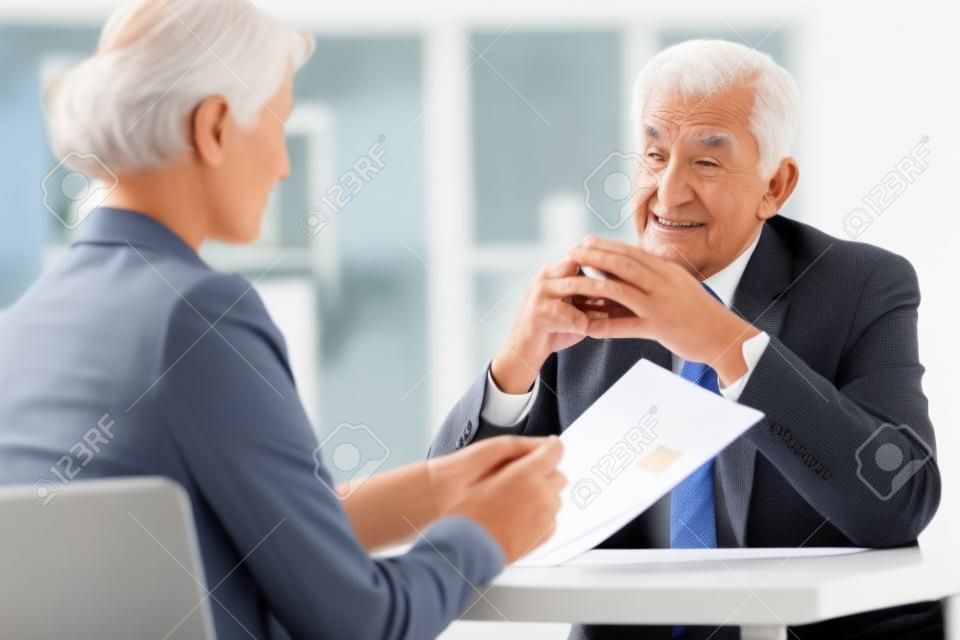 Elder man answering the questions on job interview