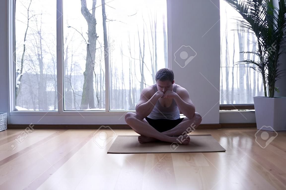 Man sitting on the floor in cross legged position