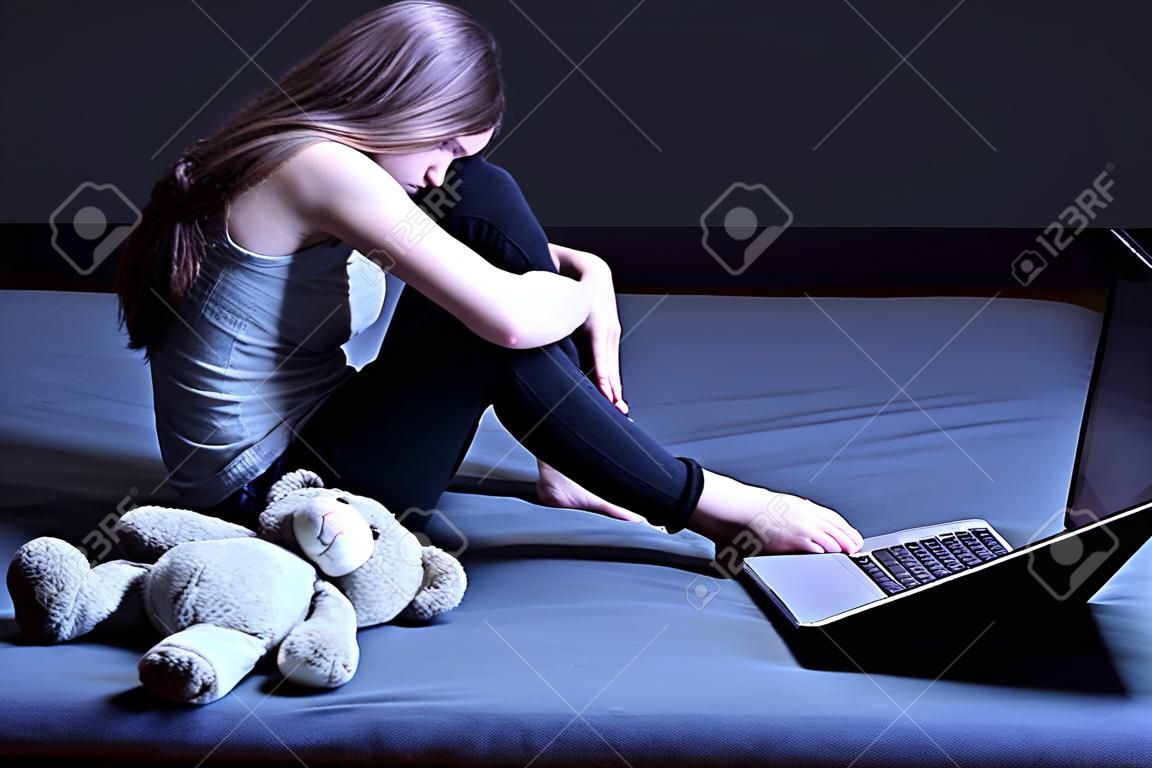 Broken down lonely teenage girl with depression sitting alone in room