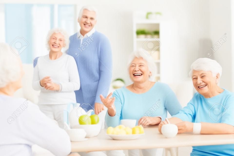 Smiling seniors having good time in nursing home