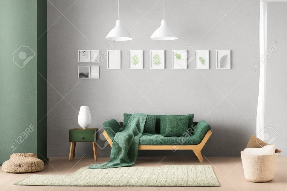 Couverture tricotée sur un canapé en bois, un pouf confortable et un panier avec des oreillers moelleux dans un intérieur de salon confortable avec des touches de vert naturel